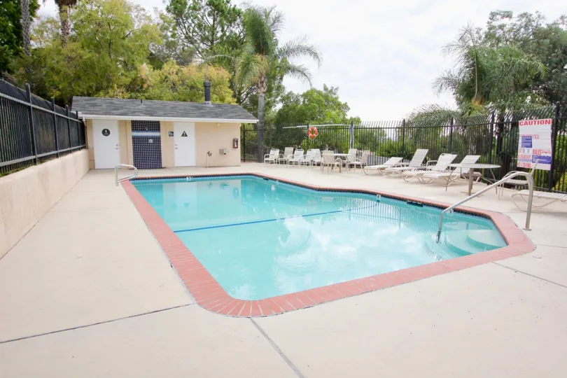 Brick ringed swimming pool with stubwall and high security fences with plenty of trees for privacy and an unobstructed view at Sunset Ridge