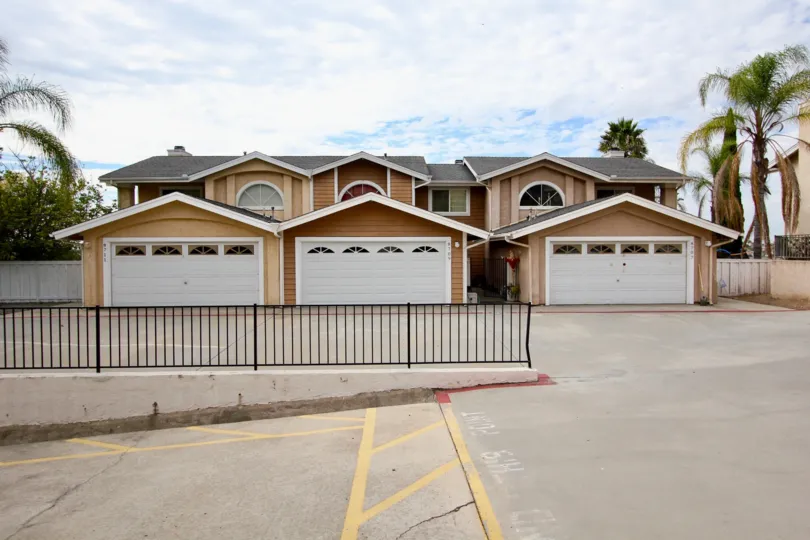 View of two-car garages and palm trees at Sunset Ridge in Spring Valley, California