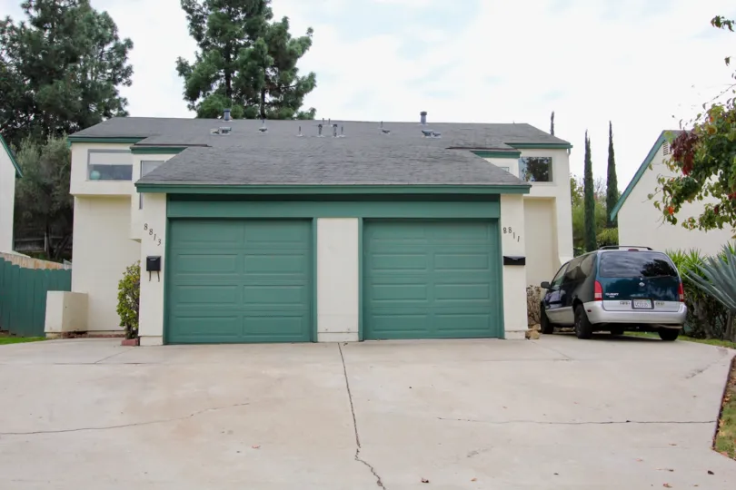 A sunny day in the area of Terra II, outside, mini van, garages, trees, parking lot, flowers