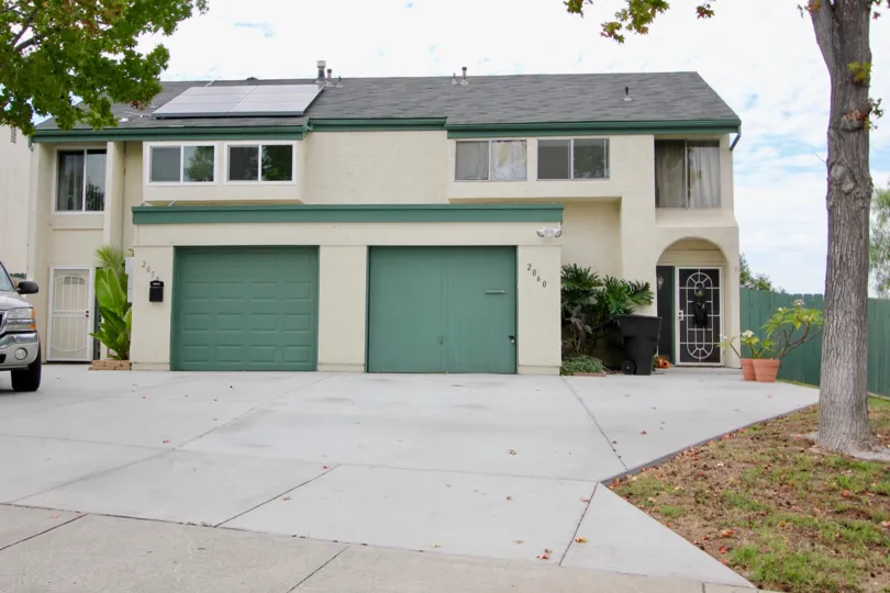 View of the front of Terra II Community with solar panels and garage doors in Spring Valley, California