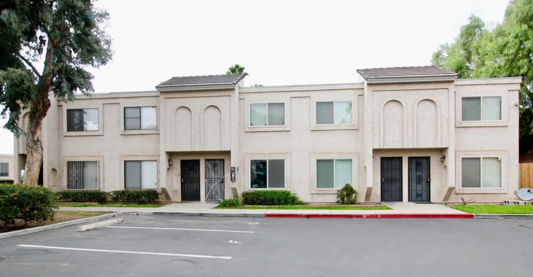 A two-storey apartment with arched walls and sliding windows in the Valley Springs community.