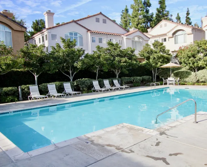 pool decorated with chair and plants and trees near the building in Andria