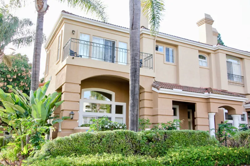 Excellent front view of a building with light pink color and plantation in Avanti.