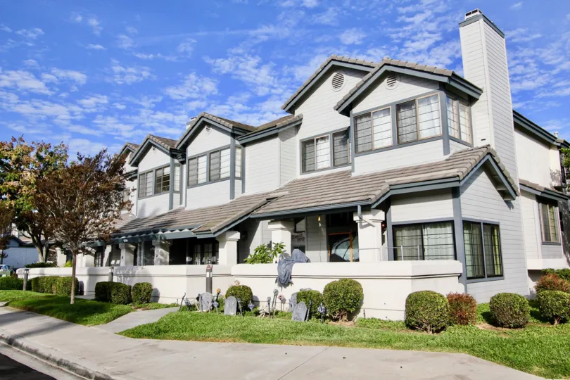 A large condo in the Cambridge Terrace community with multiple windows and a well-kept garden in front at University City, California