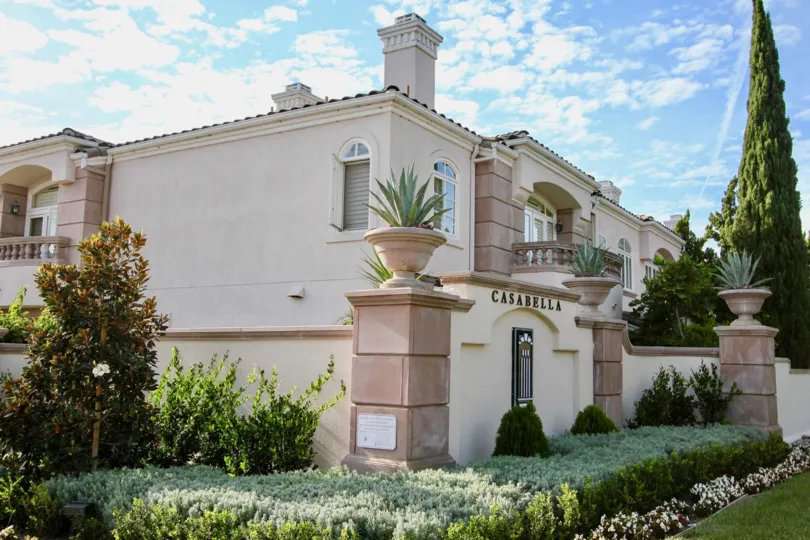A two story pink & white building located in University City CA at Casabella