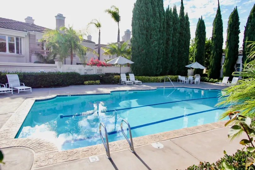 THE BUNGALOW IN THE CASABELLA WITH SWIMMING POOL, TABLES, CHAIRS, UMBRELLA, BEAUTIFUL TREES, PLANTS, FLOWERS.