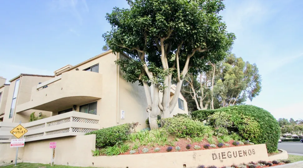 Round bushes sit in a patch of garden at the Dieguenos condos