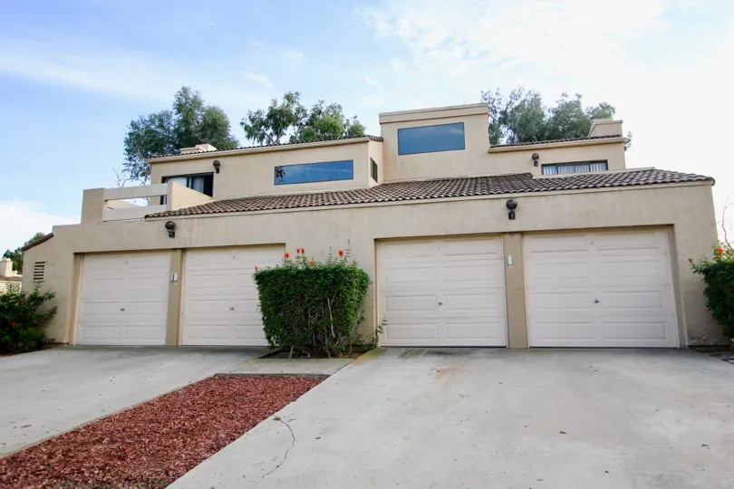 Four garage doors sit on a building in the Dieguenos condos