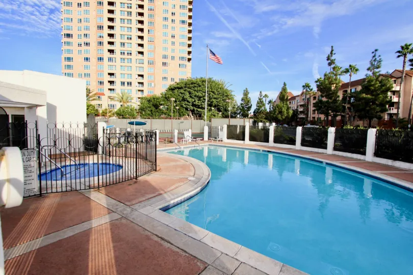 Private pool and hot tub surrounded by trees at La Jolla Garden Villas in University City, California.