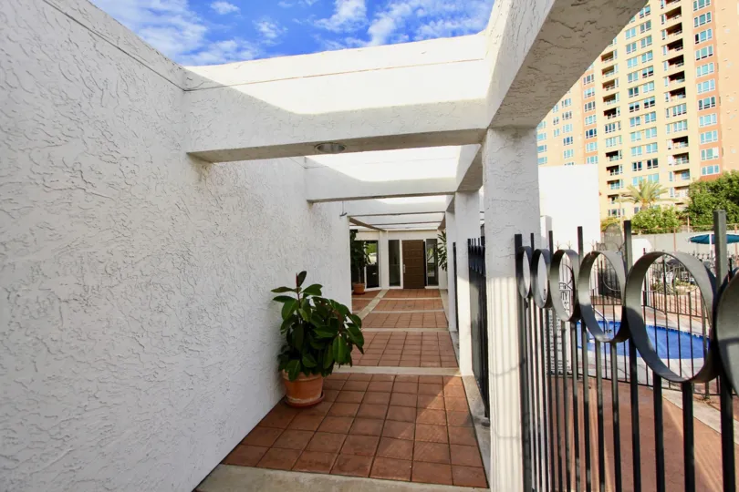 pathway view from la jolla garden villas with plas and view of a swimming pool