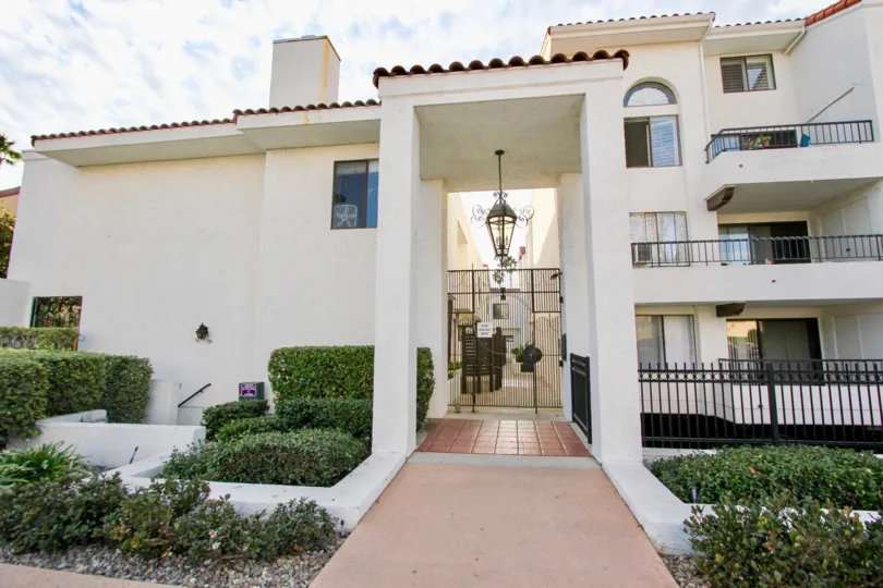 A large light hanging from a pole over an entry in La Jolla Garden Villa in University City CA