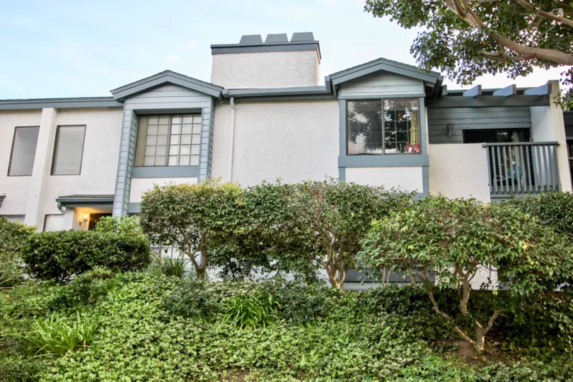 A front view with bushes of the complex in La Jolla Village Park in University City CA