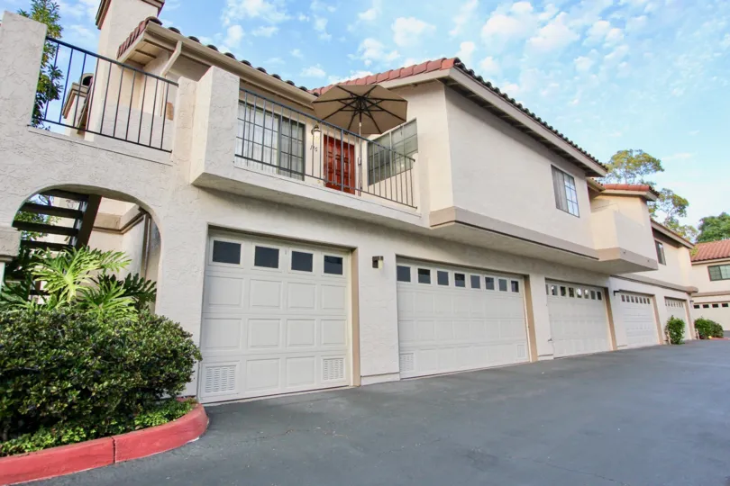 A white building with garages and an umbrella in Marbella neighborhood