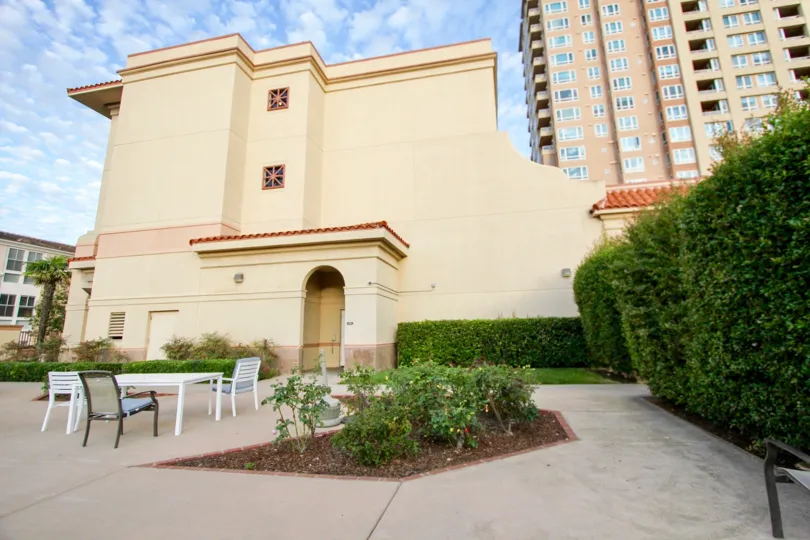 A view of the outside terrace at the Pacific Regent La Jolla showing seating and landscaping.