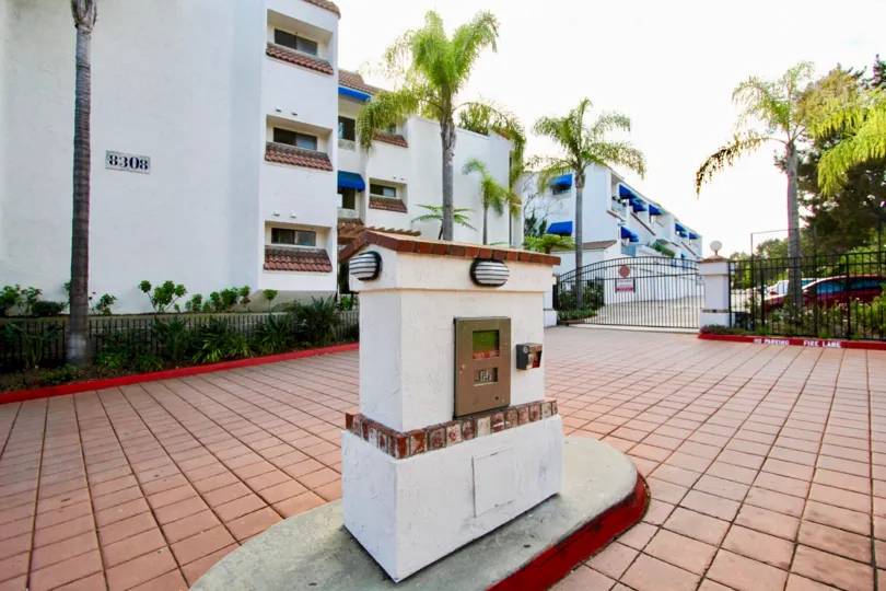 Entrance view of the building with trees and plants in Pines of La Jolla
