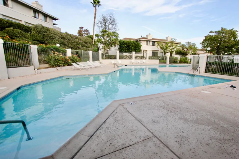 A sunny day in the Playmor Terrace West with a swimming pool and the chairs at University City California