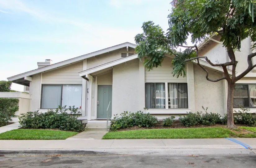 Single story home with a blue door at residence in University City CA at Playmor Terrace West