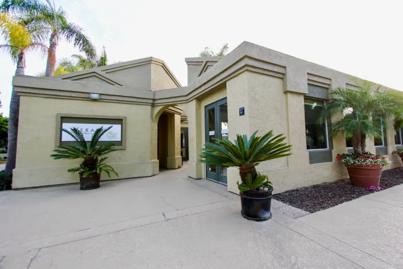 Awesome clean and neat front view with plants and tree in front of Verano
