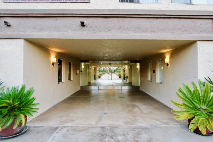 Welcoming entrance flanked by potted plants at Villa Vicenza in University City, California.