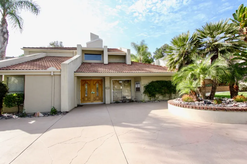 A villa style house with palm trees in the front yard and beautiful weather in Villas at University Park In University City, California