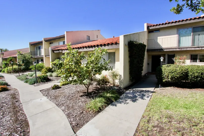 Landscaped multi-family apartment with lighted sidewalks and villa scenery