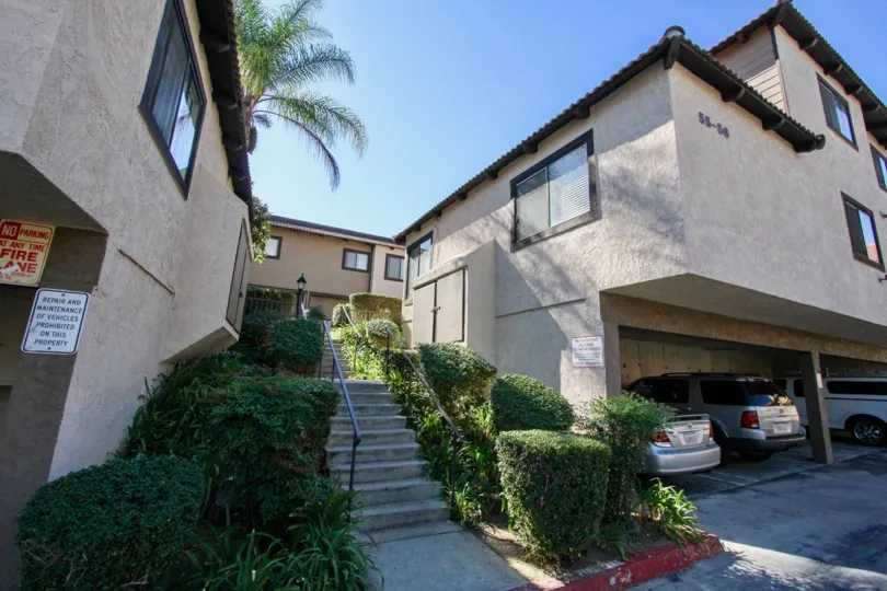A sunny day in the area of Buena Vista Tonwhouses, stairway, bushes, garage, carport, car