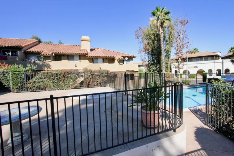 Swimming pool with metal fence at Buena Vista townhomes in Vista California