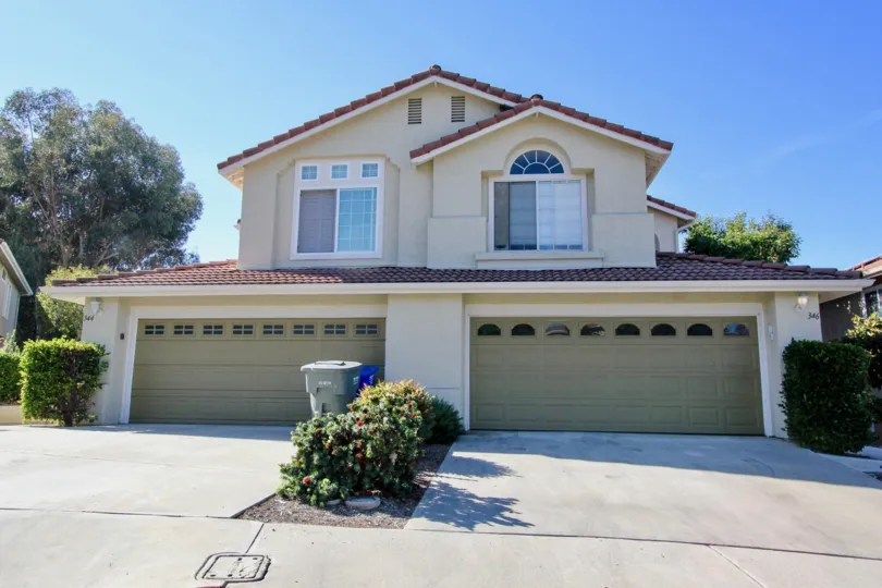 Beautiful cream colored home with a red brick roof in Vista, CA