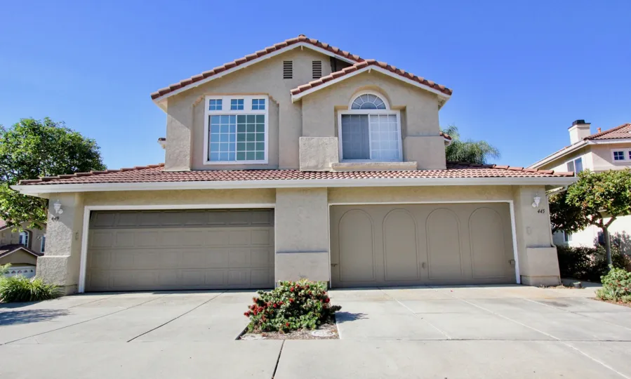 Sunny day in Vista, CA. Two garages in a two story house in California Capri community.