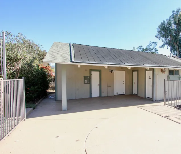 A cloudless day with the sun shining on a small house in Vista California