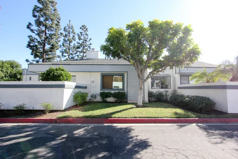 A sunny day at a white home in the Copper Hill Community in Vista, California.