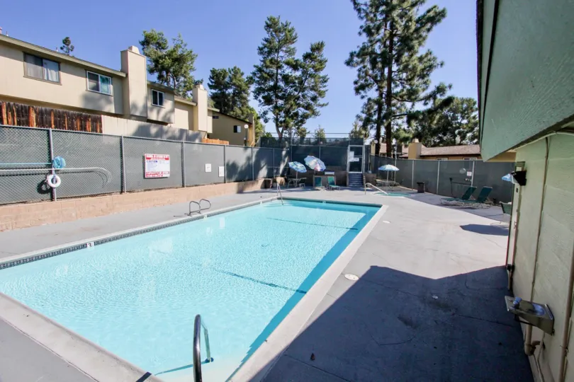 The villa in the Marlin Terrace has swimming pool and chair with umbrella on the sunny day