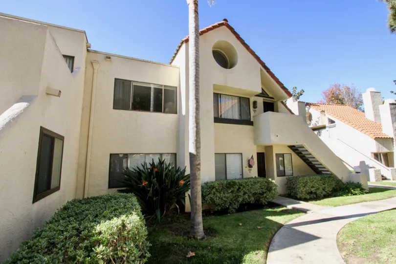 Double level residence landscaped with native flora at Melrose Park in Vista, CA