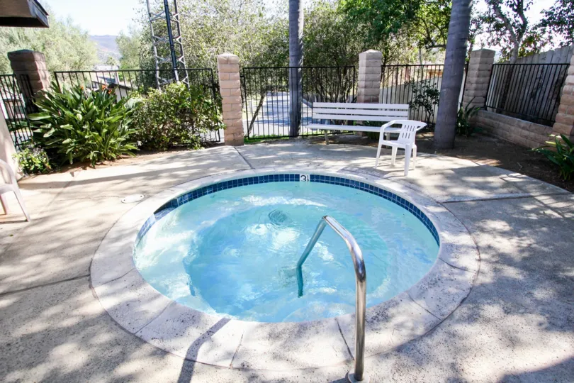 Hot tub surrounded by iron fence at Nob Hill in Vista California