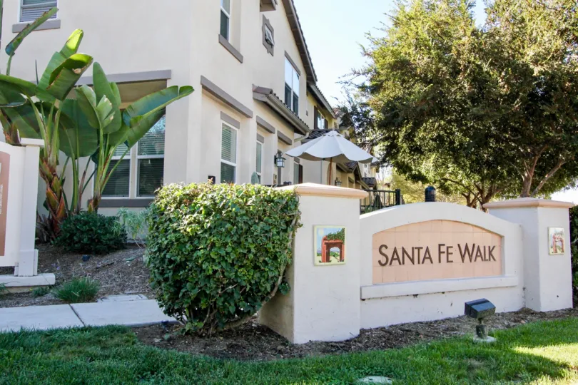 Welcome sign in a sunny neighborhood community in Santa Fe Walk