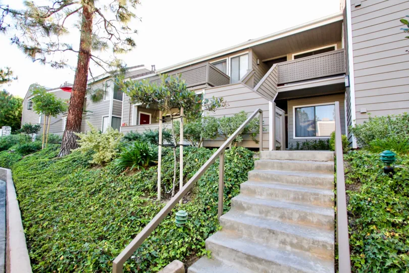 A view of the Shadowridge Aspens condos nestled in landscaped grounds with outdoor staircases and balconies.