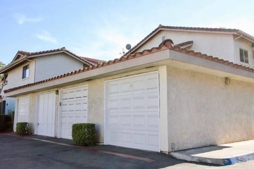 Rear garage and private parking area of condo complex in Shadowridge Glen.