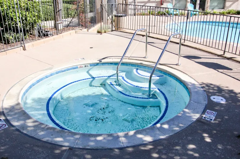 An apartment community located in the city of Vista Hills California. This picture shows a jacuzzi and a pool in the background.