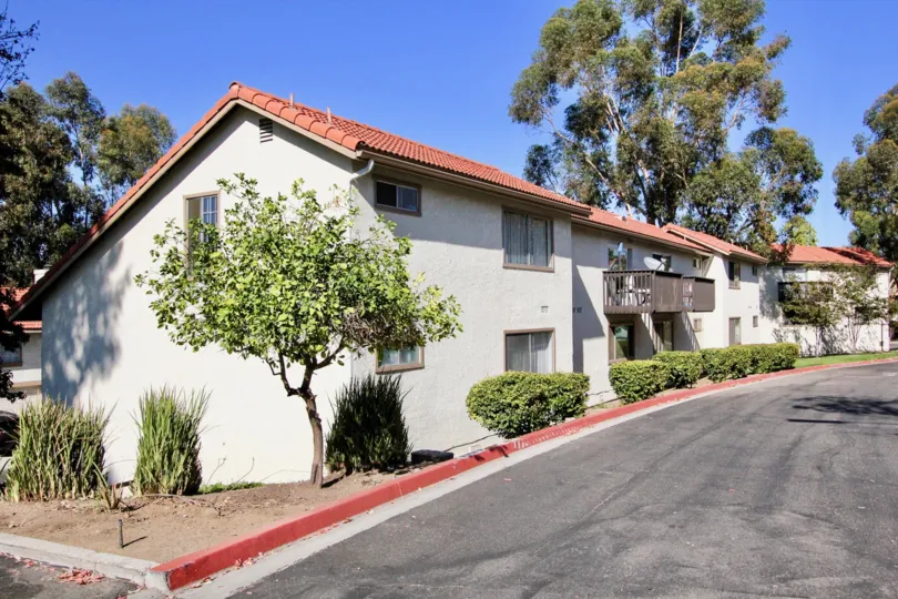 A long and wide driveway winds in front of two story town homes at Vista Knolls.
