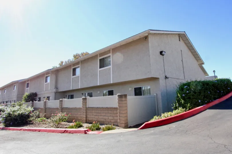 A building from Vista Ladera next to a steep curve.