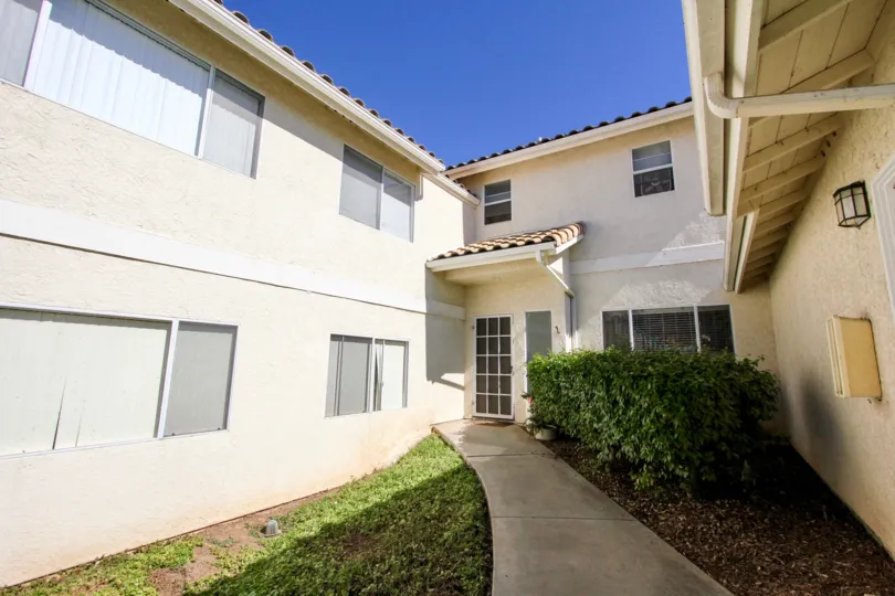 Sidewalk leading to a door in the vista polomar community in Vista,CA