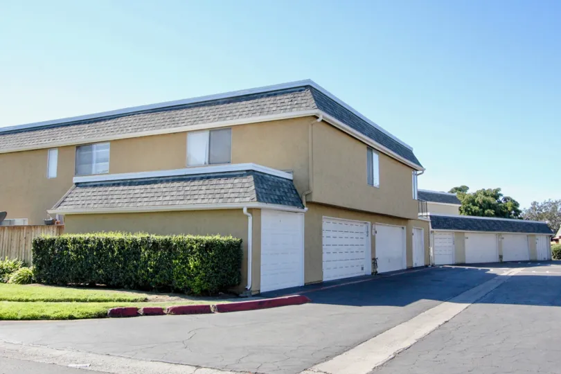 Driveway next to a residence with attached garages at Vista Park Villas