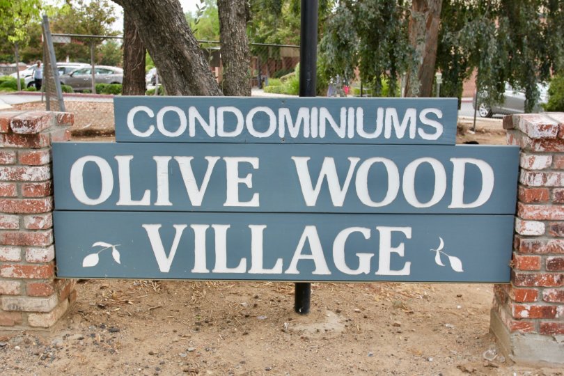Large sign for the Olive wood Village Condominiums