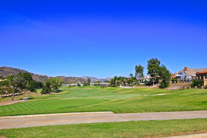 A bright, sunny day at the Fairway Estates at Bear Creek with a golf course and surrounding homes.