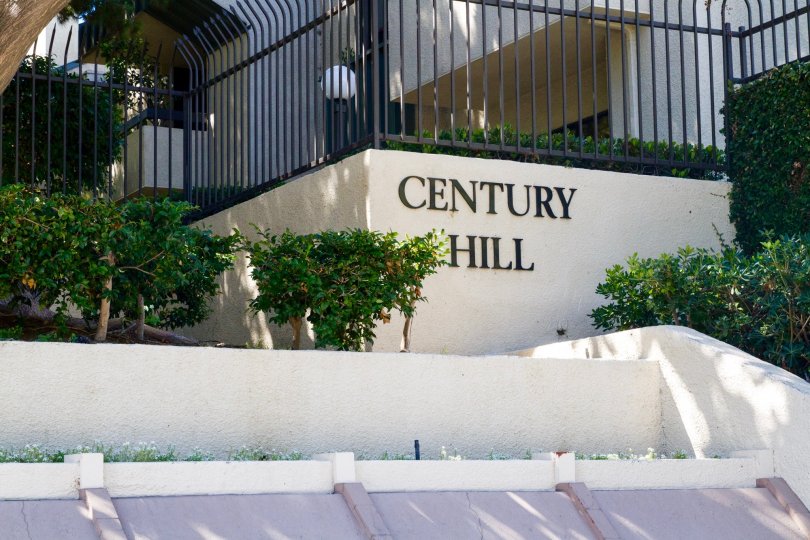 A marquee showing the Century Hill name on a stucco wall new the entrance