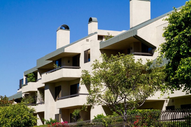 Balconies extend away from the Century Hill condo building with metal roofed overhangs