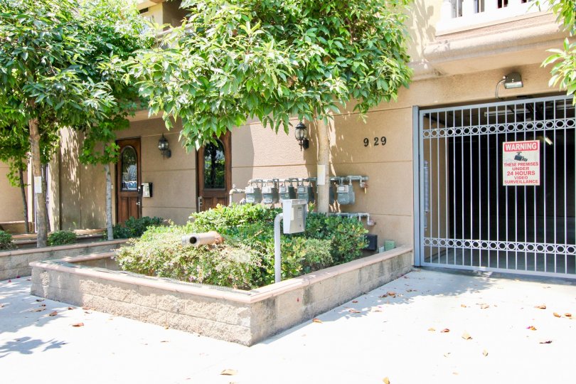 A bright day in the Arena Cove Villas with a gate front and sign board.
