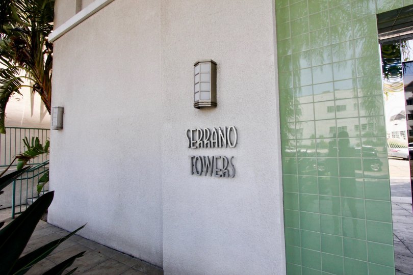 The entrance sign and Serrano Towers building in the shade in Koreatown