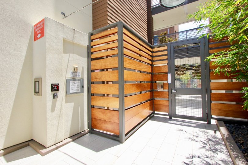 A modern and stylish security entrance gate with modern door and wood details