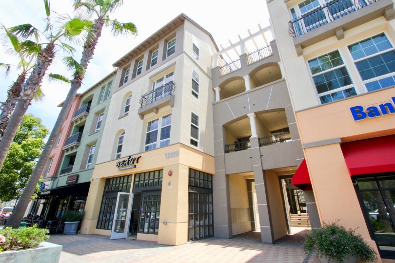 a big comercial building with trees in the front part in the lofts